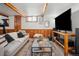 Finished basement recreation room with comfortable seating and large TV at 2042 Jamaica St, Aurora, CO 80010