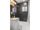 Clean bathroom with dark tile, bathtub and a white vanity at 2042 Jamaica St, Aurora, CO 80010
