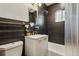 Elegant bathroom with sleek black tiles, modern fixtures, and shower with tub at 2042 Jamaica St, Aurora, CO 80010