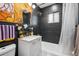 Updated bathroom with dark tile and white vanity at 2042 Jamaica St, Aurora, CO 80010