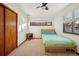 Cozy bedroom with ceiling fan, carpet, and a closet providing comfort and style at 2042 Jamaica St, Aurora, CO 80010
