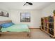 Cozy bedroom with natural light, ceiling fan, and built-in shelves with toys at 2042 Jamaica St, Aurora, CO 80010