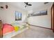 Comfortable bedroom with ample natural light, ceiling fan, and closet space at 2042 Jamaica St, Aurora, CO 80010