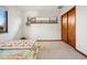Bright bedroom with a full-size bed and sliding closet doors at 2042 Jamaica St, Aurora, CO 80010