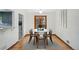 Bright dining room featuring seating for six, hardwood floors, and a modern aesthetic at 2042 Jamaica St, Aurora, CO 80010