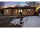 Charming brick home with winter touches and a landscaped front yard, creating a warm and welcoming atmosphere at 2042 Jamaica St, Aurora, CO 80010