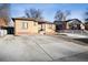 Well-maintained brick home with a spacious front yard and driveway, offering ample parking space at 2042 Jamaica St, Aurora, CO 80010