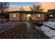 Inviting brick home at sunset with a landscaped front yard, creating a warm and welcoming atmosphere at 2042 Jamaica St, Aurora, CO 80010