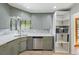 Cozy kitchen featuring gray cabinetry, stainless steel appliances, and built-in microwave at 2042 Jamaica St, Aurora, CO 80010