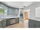 Bright kitchen with gray cabinetry, stainless steel appliances, and a well-lit window at 2042 Jamaica St, Aurora, CO 80010