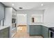 Updated kitchen with stainless steel appliances, gray cabinets, and a breakfast bar at 2042 Jamaica St, Aurora, CO 80010