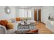 Light-filled living room featuring a curved sectional sofa and wood floors at 2042 Jamaica St, Aurora, CO 80010