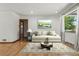 Bright living room featuring hardwood floors, a comfortable couch and large windows at 2042 Jamaica St, Aurora, CO 80010