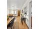 Open-concept space with a modern kitchen and living area featuring hardwood floors and stylish decor at 2042 Jamaica St, Aurora, CO 80010