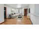 Inviting living room with hardwood floors, a cozy sofa, and ample natural light for comfortable living at 2042 Jamaica St, Aurora, CO 80010