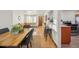 Open-concept living area with hardwood floors, dining table, and comfortable seating at 2042 Jamaica St, Aurora, CO 80010