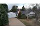 Aerial view of a home with a two-car garage, mature trees, and a well-kept lawn enhancing curb appeal at 3201 S Albion St, Denver, CO 80222