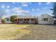 Expansive backyard featuring a charming home with a covered patio and a well-maintained lawn at 3201 S Albion St, Denver, CO 80222