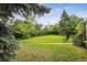 Large, level backyard featuring a well-maintained lawn, mature trees, and privacy fencing for outdoor enjoyment at 3201 S Albion St, Denver, CO 80222