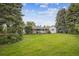 Expansive backyard with a well-kept lawn, mature trees, and a covered patio perfect for outdoor entertaining at 3201 S Albion St, Denver, CO 80222