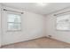 Bright bedroom featuring two windows and neutral carpet at 3201 S Albion St, Denver, CO 80222