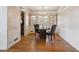 Bright dining room with hardwood floors, a chandelier, and multiple windows providing ample natural light at 3201 S Albion St, Denver, CO 80222