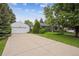 Well-maintained home exterior featuring a spacious driveway, lush landscaping, and an attached two-car garage at 3201 S Albion St, Denver, CO 80222