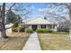 Inviting front entrance with a covered porch and neatly trimmed bushes at 3201 S Albion St, Denver, CO 80222