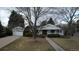 Charming front exterior with a well-manicured lawn, mature trees and a two car garage at 3201 S Albion St, Denver, CO 80222