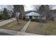 Charming front exterior with a well-manicured lawn, mature trees and a welcoming walkway at 3201 S Albion St, Denver, CO 80222