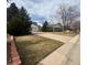 Traditional home with a spacious driveway and well-manicured front yard featuring mature trees at 3201 S Albion St, Denver, CO 80222