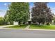 Home's exterior featuring mature trees, a lush lawn, and a walkway leading to the welcoming front entrance at 3201 S Albion St, Denver, CO 80222