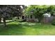 Charming home featuring a lush green lawn and mature trees in a serene front yard setting at 3201 S Albion St, Denver, CO 80222
