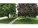Charming home with lush landscaping, mature trees, and a walkway at 3201 S Albion St, Denver, CO 80222