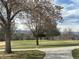 Scenic golf course view featuring lush green grass, mature trees, and distant mountain views, providing a serene and picturesque setting at 3201 S Albion St, Denver, CO 80222
