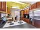 Vintage kitchen with wood cabinets, black countertops, and adjacent dining area at 3201 S Albion St, Denver, CO 80222