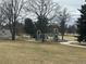 Playground equipment in a park setting, with mature trees and walking paths at 3201 S Albion St, Denver, CO 80222