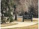 Sign for Magna Carta Park, set amongst grass and trees, adjacent to a road at 3201 S Albion St, Denver, CO 80222