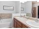 Bathroom features a double sink vanity, large mirror, and a separate bathtub and glass shower at 3662 S Perth Cir # 104, Aurora, CO 80013