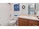 Cozy full bathroom featuring a shower-tub combo, wood vanity, and decorative wall art at 3662 S Perth Cir # 104, Aurora, CO 80013
