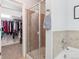 Bright bathroom showcases glass shower with tiled surround and access to a walk-in closet at 3662 S Perth Cir # 104, Aurora, CO 80013