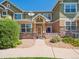 Charming townhome exterior with stone accents, a quaint porch, and well-maintained landscaping enhancing curb appeal at 3662 S Perth Cir # 104, Aurora, CO 80013