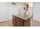 Well-organized kitchen featuring an island with granite countertops, ample storage, and easy access to the staircase at 3662 S Perth Cir # 104, Aurora, CO 80013