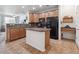 Modern kitchen featuring an island, granite countertops, stainless steel sink and tile floors, perfect for cooking and entertaining at 3662 S Perth Cir # 104, Aurora, CO 80013