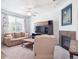 Inviting living room featuring a cozy sofa, a media center, and a fireplace for added comfort and style at 3662 S Perth Cir # 104, Aurora, CO 80013