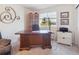 Home office space with a large wood desk, built-in bookcase, and natural light from the window at 3662 S Perth Cir # 104, Aurora, CO 80013