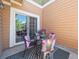 Cozy patio with outdoor seating, a decorative rug, and a sliding glass door at 3662 S Perth Cir # 104, Aurora, CO 80013