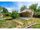 View of back yard with grass, trees, foliage, patio, and a two-story home at 6953 Ingalls St, Arvada, CO 80003