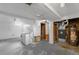Utility area with washer, dryer, and hot water heater; unfinished walls and concrete floor at 6953 Ingalls St, Arvada, CO 80003