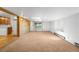 Bright basement with access to the backyard and kitchen, featuring wood paneling and ample space for various activities at 6953 Ingalls St, Arvada, CO 80003